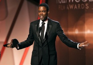 In this Nov. 14, 2014 file photo, Chris Rock accepts the Hollywood comedy film award on stage at the Hollywood Film Awards at the Palladium in Los Angeles.  The largest black audience for the Academy Awards over the last dozen years came in 2005, when  Rock was host and Jamie Foxx and Morgan Freeman won the top male acting awards. Rock will be back as host this year, on Feb. 28, 2016, but it's an open question how many black viewers will be tuning in. (Photo by Chris Pizzello/Invision/AP)