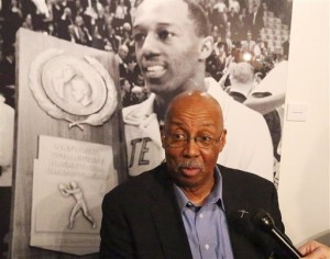 Nevil Shed, a member of the 1966 Texas Western College basketball NCAA championship team speaks of his recollections about the teams title game an an exhibit about the team on the UTEP campus Thursday, Feb. 4, 2016. The historic photo behind him is of teammate Orsten Artis. (Rudy Gutierrez/The El Paso Times via AP) EL DIARIO OUT; JUAREZ MEXICO OUT; MANDATORY CREDIT IF USE ON LAM OR LAT AND EL DIARIO DE EL PASO OUT