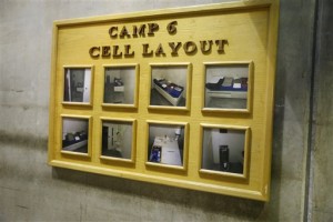 In this Feb. 6, 2016 photo, a board showing multiple photos of a cell in Camp 6 is seen at the U.S. detention center in Guantanamo Bay, Cuba. (AP Photo/Ben Fox)