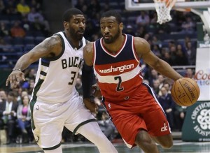 Washington Wizards' John Wall (2) drives against Milwaukee Bucks' O.J. Mayo (3) during an NBA basketball game Thursday, Feb. 11, 2016, in Milwaukee. (AP Photo/Aaron Gash)