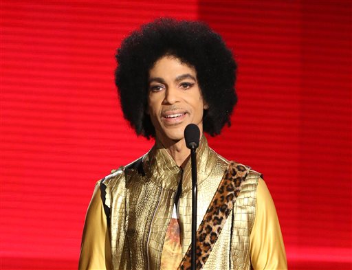 In this Nov. 22, 2015 file photo, Prince presents the award for favorite album - soul/R&B at the American Music Awards in Los Angeles. Pop icon Prince is writing a memoir to be released next year. Publisher Spiegel & Grau announced Friday, March 18, 2016, it has acquired Princes untitled book, which will be released in the fall of 2017.(Photo by Matt Sayles/Invision/AP, File)