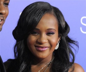 In this Aug. 16, 2012, file photo, Bobbi Kristina Brown attends the Los Angeles premiere of "Sparkle" at Grauman's Chinese Theatre in Los Angeles. A medical examiner said Browns face being immersed in water, along with drug intoxication, led to her death last year. The Fulton County Medical Examiners office in Atlanta released a statement Friday, March 4, 2016, on the death as it prepares to release the full autopsy report. (Photo by Jordan Strauss/Invision/AP, File)