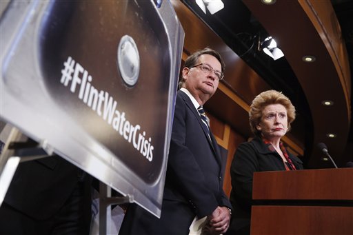 In this Jan. 28, 2016, file photo, Sen. Gary Peters, D-Mich., left, and Sen. Debbie Stabenow, D-Mich., listen to a question as they discuss proposed legislation to help Flint, Mich. with their current water crisis during a news conference on Capitol Hill in Washington. Its been two years since problems began with the drinking water in Flint, Michigan, and nearly six months since officials declared a public health emergency. Yet a bipartisan congressional effort to aid the predominantly African-American city is idling in the Senate. (AP Photo/Alex Brandon, File)