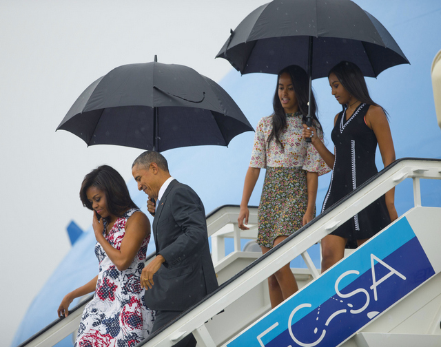 President Barack Obama, second from left, arrives with first lady Michelle Obama, left, and their daughters Sasha, right, and Malia, as they exit Air Force One at the airport in Havana, Cuba, Sunday, March 20, 2016. Obama and his family are traveling to Cuba, the first U.S. president to visit the island in nearly 90 years.. (AP Photo/Pablo Martinez Monsivais)
