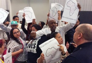 Protesters interrupt a meeting of the Los Angeles Police Commission on Tuesday, March 1, 2016, to decry the shooting of a homeless black man by the LAPD exactly one year ago. The protest came the same day the police department released a report showing that when LAPD officers fire at suspects, their targets are disproportionately black and mentally ill. (AP Photo/Amanda Lee Myers)