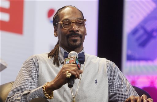 In this March 20, 2015 file photo, rapper Snoop Dogg takes part in the "Keynote Conversation with Snoop Dogg" at the South by Southwest festival in Austin, Texas. The rapper is providing commentary for nature and other videos on "Planet Snoop," a new series on his Merry Jane website. (Jack Plunkett/Invision via AP, File)