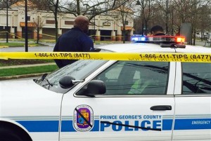 Prince George's County police block the road to the police station, Monday morning, March 14, 2016 in Hyattsville, Md.  Police and the public were seeking answers Monday after a gunman opened fire outside a police station Sunday afternoon in a Maryland suburb of the nation's capital, killing an officer in what the police chief called an "unprovoked attack."  (AP Photo/Jessica Gresko)
