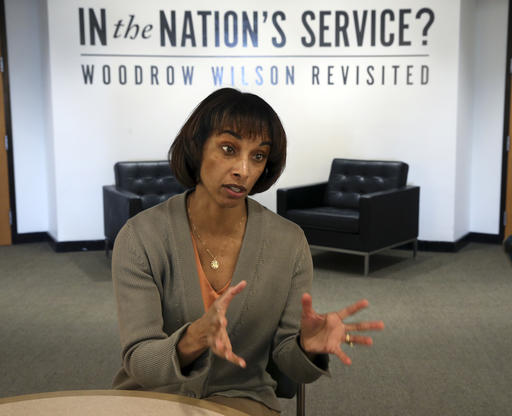 Cecilia Rouse, Dean of the Woodrow Wilson School of Public and International Affairs, answers a question as she sits near an exhibit titled, "In the Nation's Service? Woodrow Wilson Revisited," Sunday, April 3, 2016, at the school in Princeton, N.J. As Princeton University officials weigh whether to remove alumnus and former President Woodrow Wilson's name from its public policy school, the college is launching an exhibit meant to more fully air his legacy. The Nobel Peace Prize winner heralded as a progressive hero has also faced criticism as a racist who encouraged segregation in his administration. (AP Photo/Mel Evans)