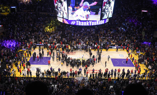 Los Angeles Lakers forward Kobe Bryant speaks to fans after the Lakers' NBA basketball game against the Utah Jazz, Wednesday, April 13, 2016, in Los Angeles. Bryant scored 60 points in his final NBA game as the Lakers won 101-96. (AP Photo/Mark J. Terrill)