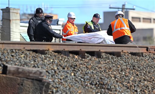 Police and investigators cover the body of one of the individuals killed in an Amtrak train crash in Chester, Pa., Sunday, April 3, 2016. The Amtrak train struck a piece of construction equipment just south of Philadelphia causing a derailment. (Michael Bryant/The Philadelphia Inquirer via AP)  PHIX OUT; TV OUT; MAGS OUT; NEWARK OUT; MANDATORY CREDIT