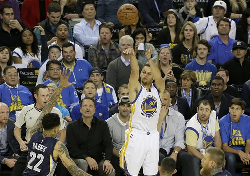 Golden State Warriors guard Stephen Curry (30) shoots a three point basket against the Memphis Grizzlies during the first half of an NBA basketball game in Oakland, Calif., Wednesday, April 13, 2016. (AP Photo/Jeff Chiu)