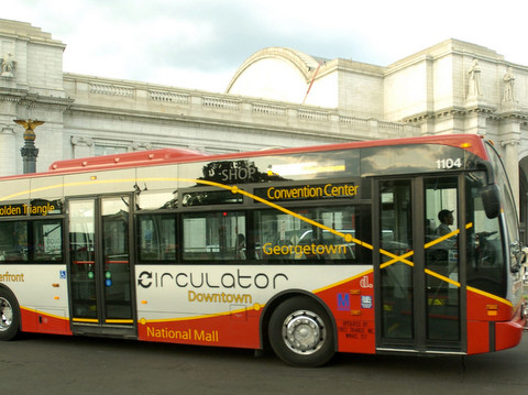 The Downtown Circulator bus drives by Union Station on Friday, July 7, 2006, in Washington. After a year of operation, the Downtown Circulator is being hailed as a success by business leaders, city officials, tourists, commuters and shoppers. While ridership is low, compared the Metrorail system's 18.7 million riders a month, the short haul circulators carry passengers to areas they can't reach by rail. They include the Southwest Waterfront entertainment district and Georgetown's shops and restaurants. (AP Photo/Leslie E. Kossoff)