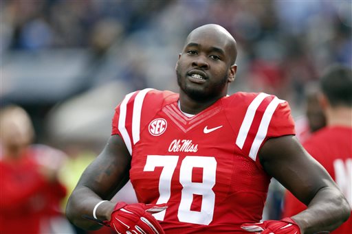 In this Oct. 24, 2015 file photo, Mississippi offensive lineman Laremy Tunsil (78) loosens up prior to his team's NCAA college football game against Texas A&M in Oxford, Miss. Mississippi will investigate former offensive lineman Laremy Tunsil's comments that he accepted money from a member of the football staff while playing at the school. The university said in a statement Friday, April 29, 2016, it is "aware of the reports from the NFL Draft regarding Laremy Tunsil and potential NCAA violations during his time at Ole Miss" and "will aggressively investigate and fully cooperate with the NCAA and the SEC." Tunsil was selected 13th overall Thursday night in the NFL draft by the Miami Dolphins (AP Photo/Rogelio V. Solis, File)