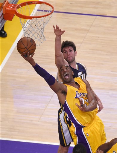 Los Angeles Lakers forward Kobe Bryant, below, shoots as Utah Jazz center Jeff Withey defends during the first half of an NBA basketball game, Wednesday, April 13, 2016, in Los Angeles. (AP Photo/Mark J. Terrill)