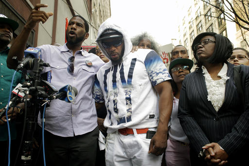 New York City councilman Jumaane Williams, left, speaks as Shanduke McPhatter, center, and his mother Rose McPhatter, right, listen during a news conference outside of Irving Plaza Thursday, May 26, 2016, in New York. Ronald McPhatter, 33, was fatally shot and others were injured in the shooting at Irving Plaza before a T.I. concert Wednesday night. (AP Photo/Frank Franklin II)