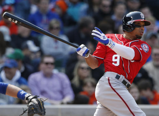 Washington Nationals' Ben Revere hits a double against the Chicago Cubs during the third inning of a baseball game Saturday, May 7, 2016, in Chicago. (AP Photo/Nam Y. Huh)