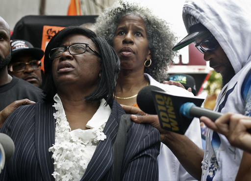 Shanduke McPhatter, right, comforts his mother Rose McPhatter as she speaks about her son Ronald McPmchatter during a news conference outside of Irving Plaza, Thursday, May 26, 2016, in New York. McPhatter, 33, was fatally shot and others were injured in the shooting at Irving Plaza before a T.I. concert Wednesday night. (AP Photo/Frank Franklin II)