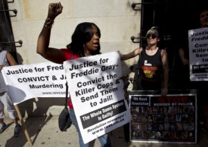 Demonstrators protest outside of the courthouse during the trial of Officer Caesar Goodson Jr., one of six Baltimore city police officers charged in connection to the death of Freddie Gray, during the third day of his trial, Monday, June 13, 2016, in Baltimore Md. Goodson, the wagon driver facing second-degree murder, manslaughter and other charges stemming from the death of Freddie Gray. Porter's trial in the Gray case ended in mistrial. He will be tried again in September. (AP Photo/Jose Luis Magana)
