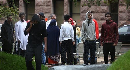 People, some of which left the Federal Courthouse, linger outside after a verdict was read an Islamic State-related case Friday, June 3, 2016, in Minneapolis. Three Minnesota men accused of plotting to go to Syria to join the Islamic State group were convicted Friday of conspiracy to commit murder overseas - a charge that carries a possibility of life behind bars. (Jim Gehrz/Star Tribune via AP)  MANDATORY CREDIT; ST. PAUL PIONEER PRESS OUT; MAGS OUT; TWIN CITIES LOCAL TELEVISION OUT